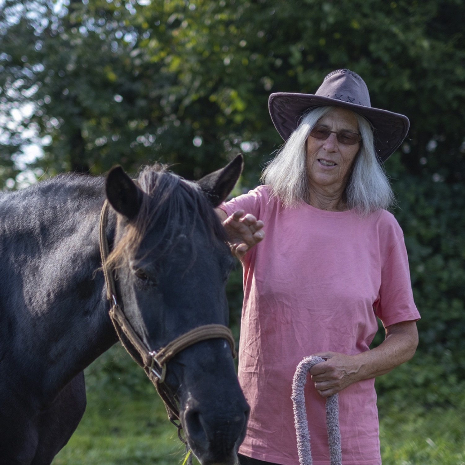 Erica Flegg, owner of La Volée, outdoors with her horses