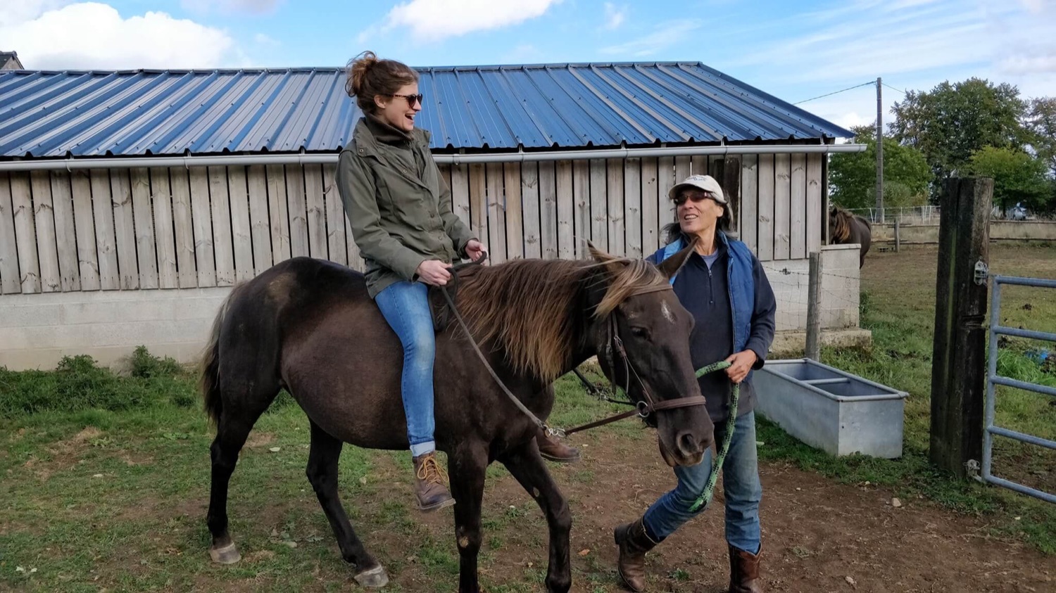 A guest riding a gaited mountain horse through the Normandy countryside at La Volée